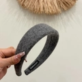 Detailed close-up of dark grey wide wool headband with handmade label and soft texture - Wide Woolen Headband / Gray