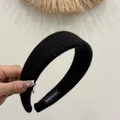 Detail of a wide black wool headband featuring a HANDMADE label and soft textured fabric - Wide Woolen Headband / Black