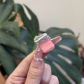 Close-up of pink mini jar nail charms with pearlescent finish on manicured nails - Mini Pink Correction Fluid