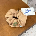Close-up of a khaki scrunchie with vintage green button detail and wooden background - Hair Tie / Champagne Button Knot Scrunchie