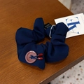 Detail of dark blue scrunchie with brown button and red capsule charms on wooden table - Hair Tie / Dark Blue Button Knot Scrunchie