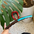 Detail view of wavy resin hair claw clip with red and blue color block oil drip finish - Blue Red Chocolate Patchwork Round Flat Style