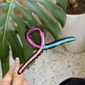 Detail of wavy drip oil hair claw clip in pink and blue held by hand for hairstyle - Blue Pink Patchwork Hanger Style