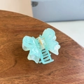 Detailed close-up of a mint green butterfly hair claw clip with a subtle pearlescent finish - Double Layer Hollow Butterfly Medium Claw / Transparent Blue