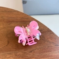 Detail view of pink acetic acid butterfly claw clip with floral purple inner layer - Double Layer Hollow Butterfly Medium Claw / Rose Pink