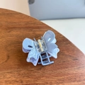 Close-up of sky blue acetate butterfly hair claw clip with metallic spring detail on wood - Double Layer Hollow Butterfly Medium Claw / Blue