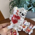 Detailed close-up of pearlescent acrylic bear hair claw clip with red KISS heart - Mermaid White Heart Kiss Bear