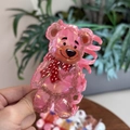 Detailed close-up of a pink acrylic teddy bear hair claw clip with polka dot scarf detail - Pink Furry Bow Bear