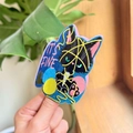 Macro shot of glittery black cat sticker entangled in colorful yarn with It's Fine text - Blue Cat Style
