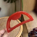 Detailed macro view of 10cm red semi-circle hair claw clip showing polished texture - 10cm / Orange Red