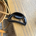 Minimalist black semi-circle hair claw clip with glossy finish on wooden table - Matte Black