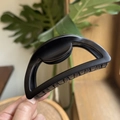 Macro detail of 10cm matte black semi-circular shark clip with sturdy hair teeth - 10cm / Matte Black