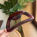 Detail of 10cm semi-circular hair claw clip in classic amber tortoiseshell pattern - 10cm / Matte Red Brown