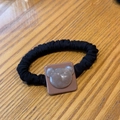 Detailed macro view of black pleated scrunchie with cute resin bear embellishment - Deep Lotus Pink Bear Hair Tie