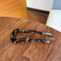 Detail view of acetate tortoise shell hair pin with golden handmade lettering - Chocolate Caramel Wave Fork