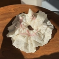 Beige lace scrunchie with pink ribbon bows on a rustic wooden surface in bright light - Pink Bow Lace Trim Scrunchie