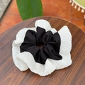 Detail of pleated black and white silk chiffon scrunchie with layered contrast design - Black & White