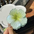 Detail of gradient flower hair claw clip with translucent petals and yellow center - Mint Green Yellow Center
