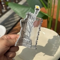Close-up of Lady Liberty acetate hair claw clip showing fine black line details and yellow torch - Statue of Liberty