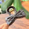 Close-up of a 8cm dark coffee double bow hair claw clip with a glossy resin finish - Chocolate