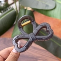 Detailed view of 8cm butterfly claw clip in dark smoky gray with strong golden spring - Coffee