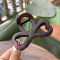 Detail showing the strong metal spring and tortoiseshell texture of the brown hair claw clip - Matte Red Brown