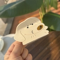 Close-up of a cute Shiba Inu acetate hair claw clip held outdoors in natural sunlight - Crayon Shiro Dog Claw Clip