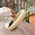 Detail of beige padded headband with waffle texture and interior handmade woven label - Beige