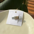 Close-up of a handmade marble pattern acetate hair clip on a white display card - Gold Green Marble