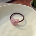 Sweet pink acetate heart hair tie with a small rhinestone bow on a ceramic plate - Sakura Pink - Bow Heart Resin Hair Tie