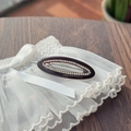 Detail of tortoiseshell oval hair clip with rhinestones and Creation France engraving - Coffee
