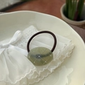 Macro detail of oval acetate hair tie with olive green resin and sparkling rhinestones - Transparent Water Green