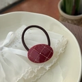Close-up of a deep red acetate hair tie with crystal rhinestones and grid pattern - Ancorra Red