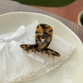 Close-up of tortoise shell pattern acetate hair claw clip with golden Barrette La France text - Brown Tortoiseshell
