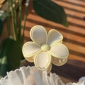 Close-up of a jelly floral hair claw clip in creamy yellow on a rustic wood background - Light Nude Pink Petal Yellow Edge Solid Color Flower Claw