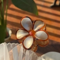 Close-up of tortoise shell resin flower hair claw with pearlized gold finish petals - Gold Glitter Petal Tortoiseshell Edge Flower Claw