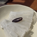 Detail of acetate tortoise shell hair clip with gold label on white lace background - Purple and Coffee