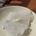 Detail of handmade cellulose acetate hair clip with iridescent pearly texture and gold logo - Shiny Mermaid