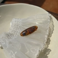 Detailed macro of tortoise shell acetate hair clip with gold France Handmade logo - Blue Tortoise