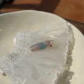 Close-up of marble pattern hair clip with gold metal base and France text detail - Shiny Pink Blue