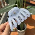 Detail of light blue glitter hair claw clip with pearlescent finish and secure metal spring - Light Blue Shimmer Pumpkin Claw