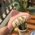 Detail of pink and cream plastic hair claw clip with multi-tooth structure for styling - Pink White Contrast Triangle Claw Clip