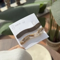 Brown and amber marble wavy acetate hair clips set on display card in outdoor setting - Agarwood Color