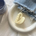 Close-up of a cream heart-shaped hair claw clip on a white plate with aesthetic decor - Creamy Yellow Hollow Heart Bow