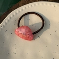 Detailansicht eines rosa Haargummis mit goldener France Handmade Gravur auf Acetat - Rosa Webstruktur - Goldetikett Haarseil