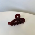 Close-up of a glossy deep red cutout hair claw clip with a sleek heart-shaped hollow design - Cherry Red Bow Small