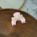 Pink acetate bow hair claw clip with marble pattern detail on a dark wooden tray - Small / Light Pink Bowknot Style