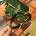 Detail view of large dark brown wavy hair claw clip with transparent resin finish - Transparent Brown
