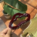 Close-up of deep red cloud-shaped hair claw clip with glossy finish and metal teeth - Ancorra Red