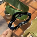 Close-up of black wavy plastic hair claw clip with glossy finish and durable teeth - Glossy Black